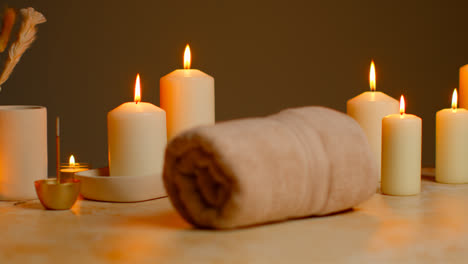 Still-Life-Of-Lit-Candles-With-Dried-Grasses-Incense-Stick-And-Soft-Towels-As-Part-Of-Relaxing-Spa-Day-Decor-7